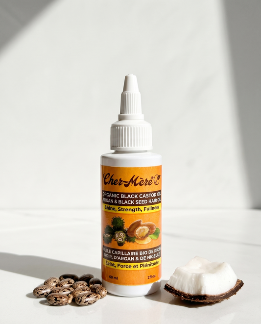 Bottle of Cher-Mere hair oil with argan and black seed ingredients on a white background