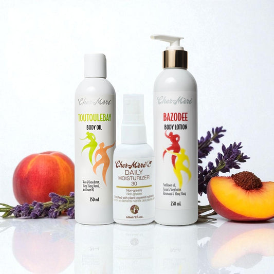 Four bottles of Cher-Mere skincare products with fruits and flowers on a white background