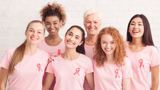 A group of women wearing breast cancer awareness shirts.