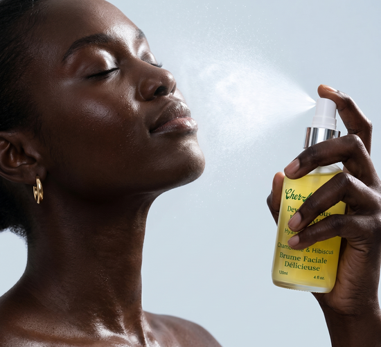 Woman holding a bottle of facial mist with a blurred background