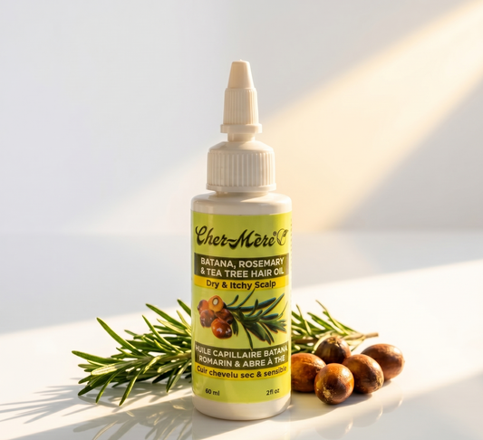 Bottle of Cher-Mere hair oil with botanical elements on a light background